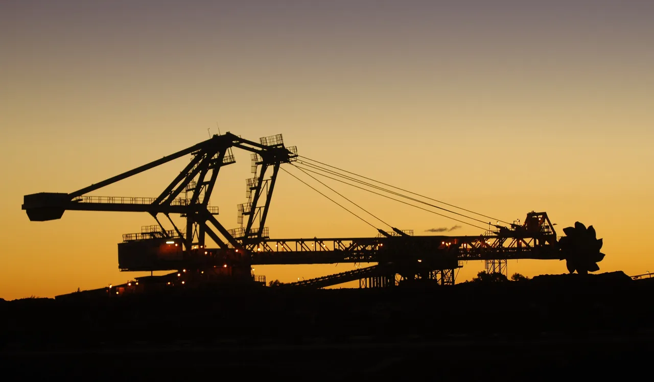 A reclaimer silhouetted against a golden sunset